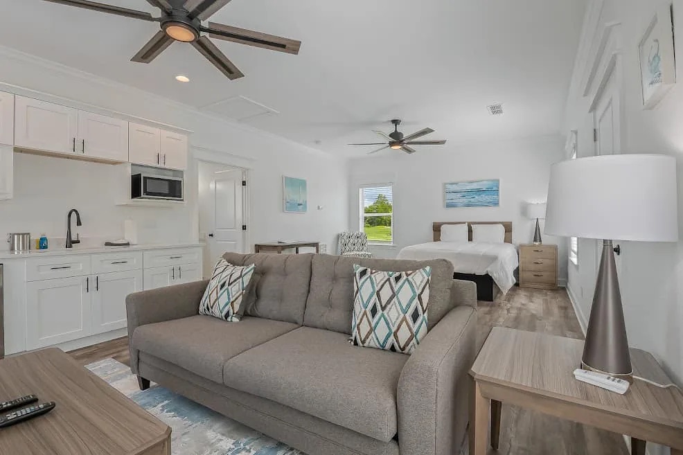 Clubhouse Villa interior with sitting area, kitchenette, and bed at St. James Bay
